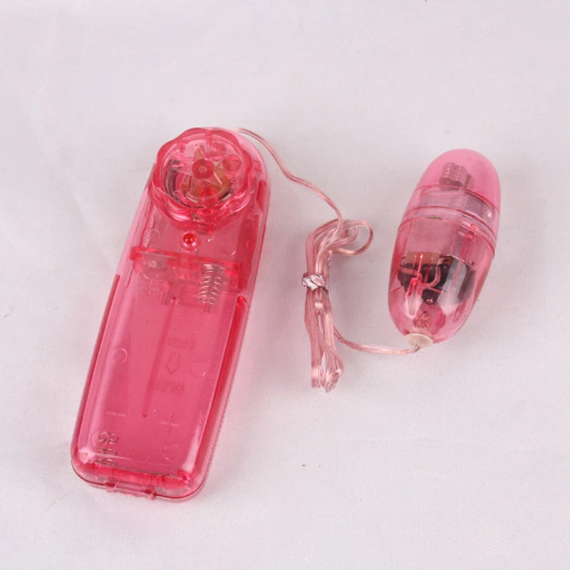 Pink translucent wired remote control and small vibrating egg on white background