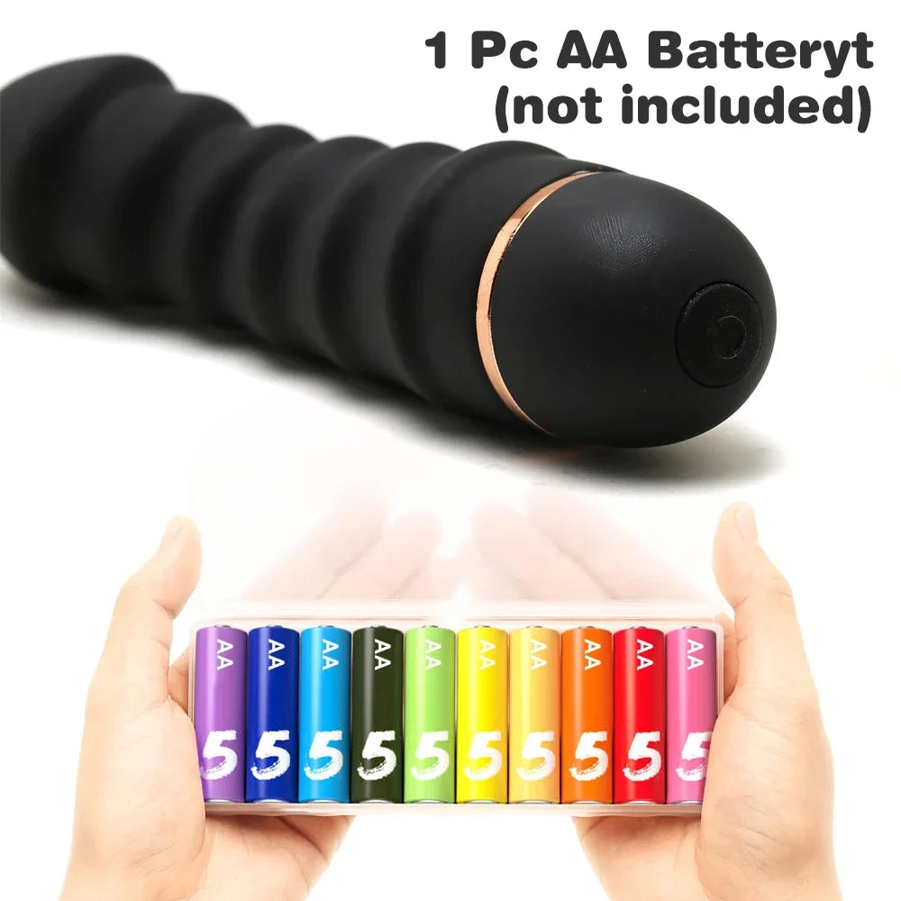 Black ribbed vibrating massager with gold accent and colorful AA batteries held in hands