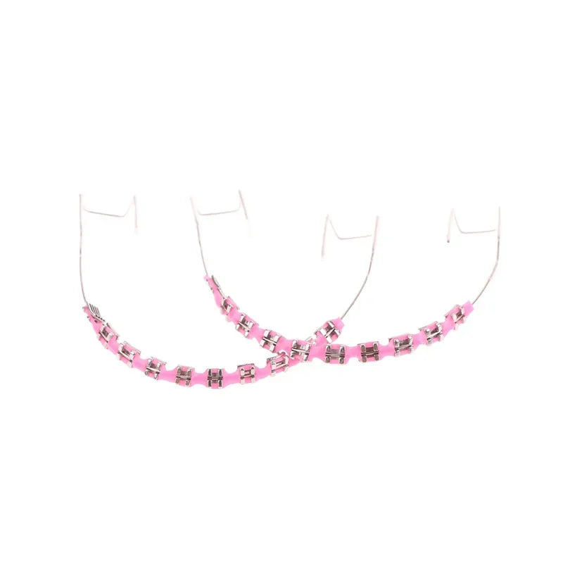 Orthodontic braces with pink ligatures on a white background for dental teeth alignment