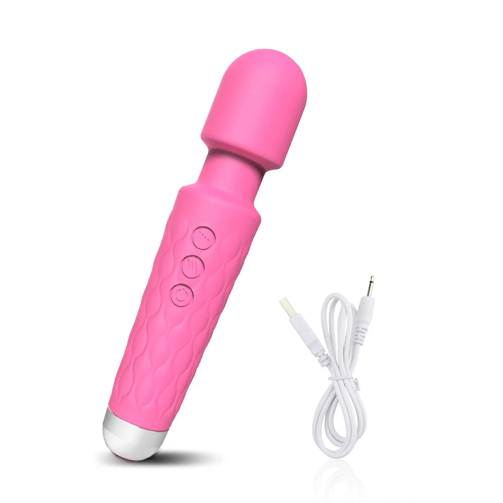 Pink handheld personal massager with textured grip and white USB charging cable