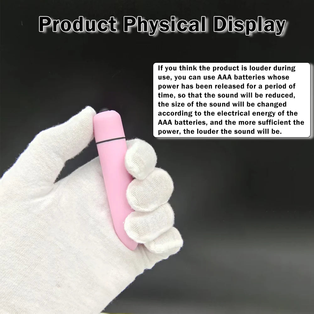 White-gloved hand holding a small pink electronic device against a black background with text instructions